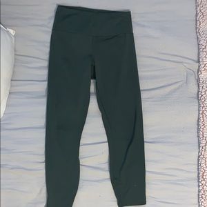 dark green leggings with cross-cross at bottom